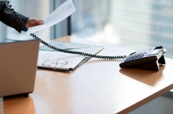 Desk with phone and laptop